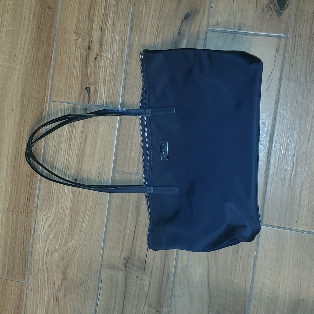 Navy blue Kate spade zippered tote. Straps have a lot of wear. See photos.